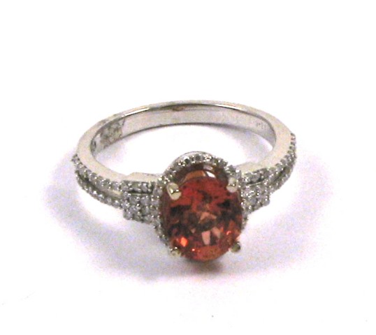 Appraisal: ORANGE SAPPHIRE AND DIAMOND RING The k white gold band