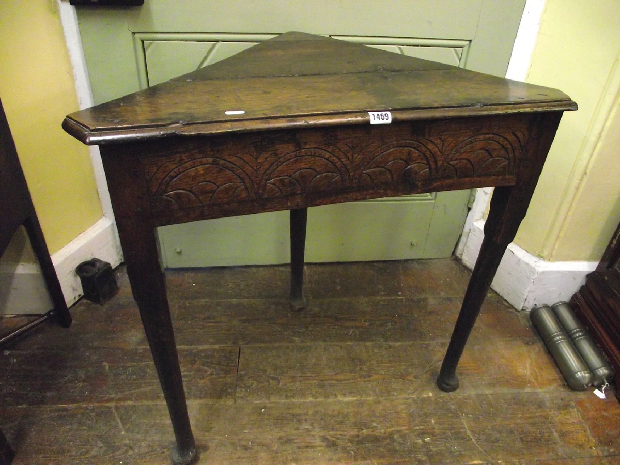 Appraisal: A simple old English oak corner table with carved frieze