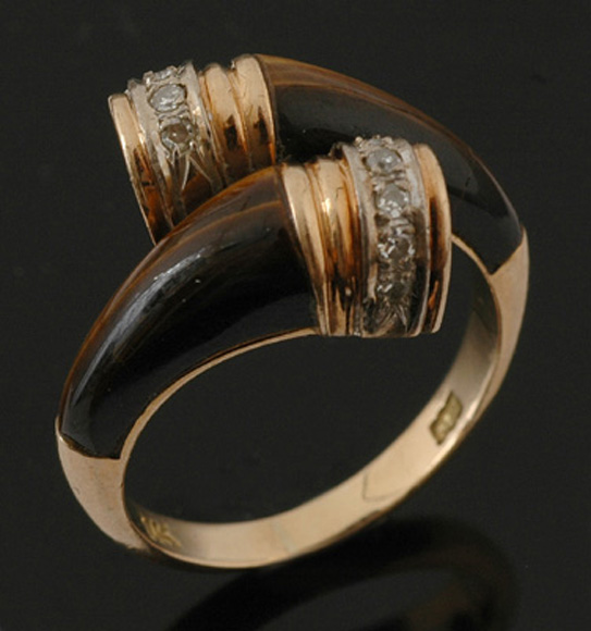 Appraisal: A tigers eye and diamond dress ring Comprising two tapered