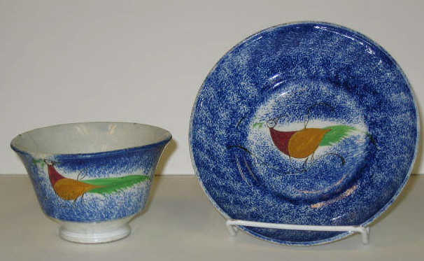 Appraisal: ENGLISH SPATTERWARE Blue spatter peafowl handless cup and saucer decorated