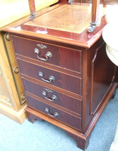 Appraisal: A mahogany filing cabinet the tooled leather top over two