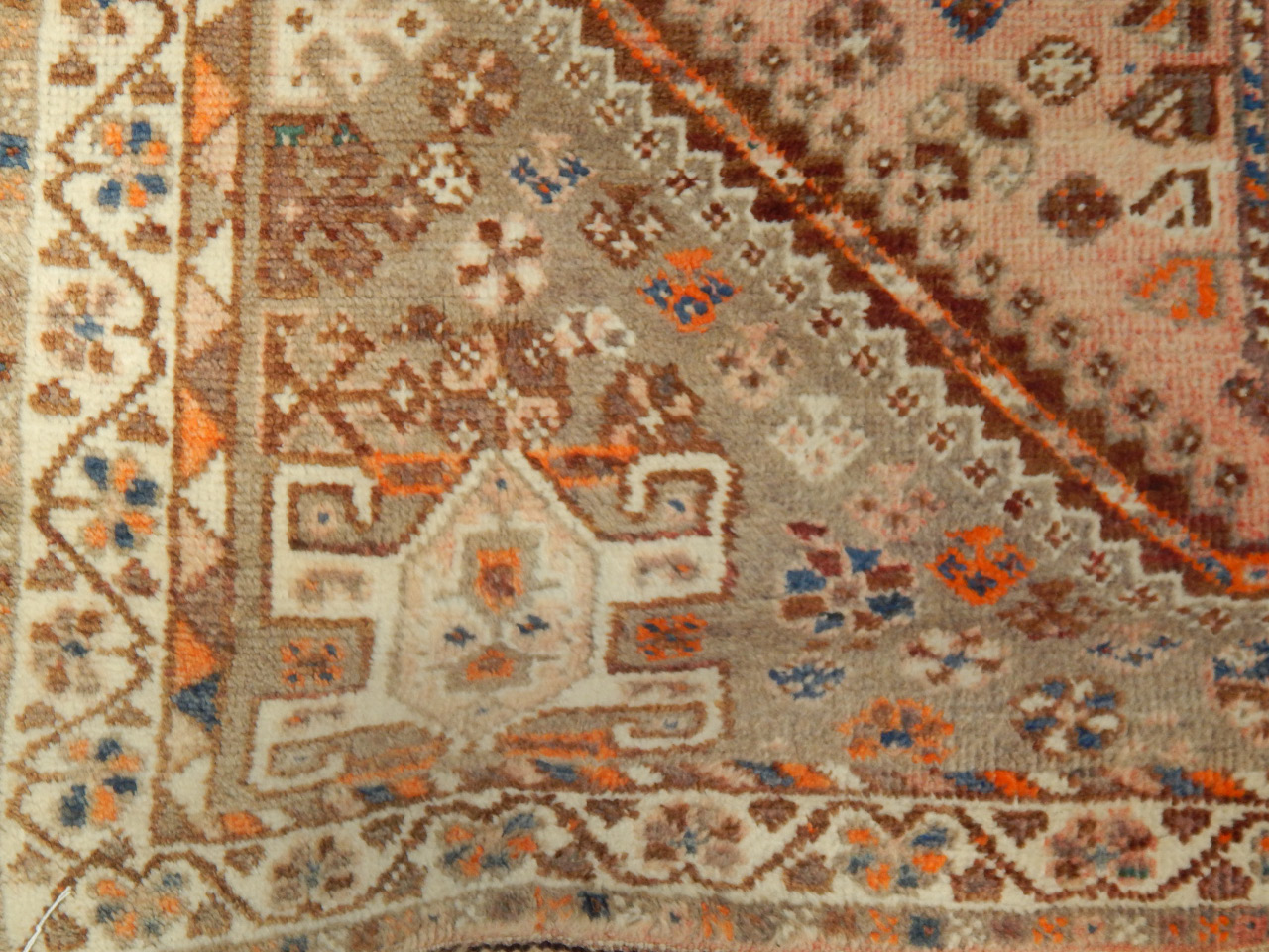 Appraisal: A Middle Eastern style rug upon brown and grey ground