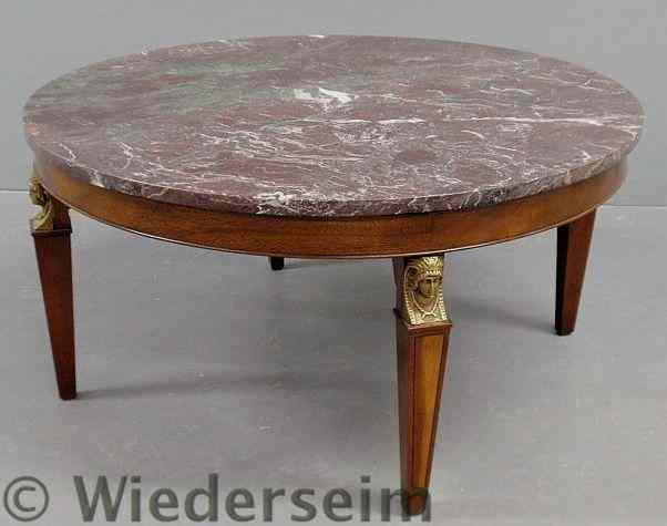 Appraisal: Round mahogany coffee table with a marble top and brass