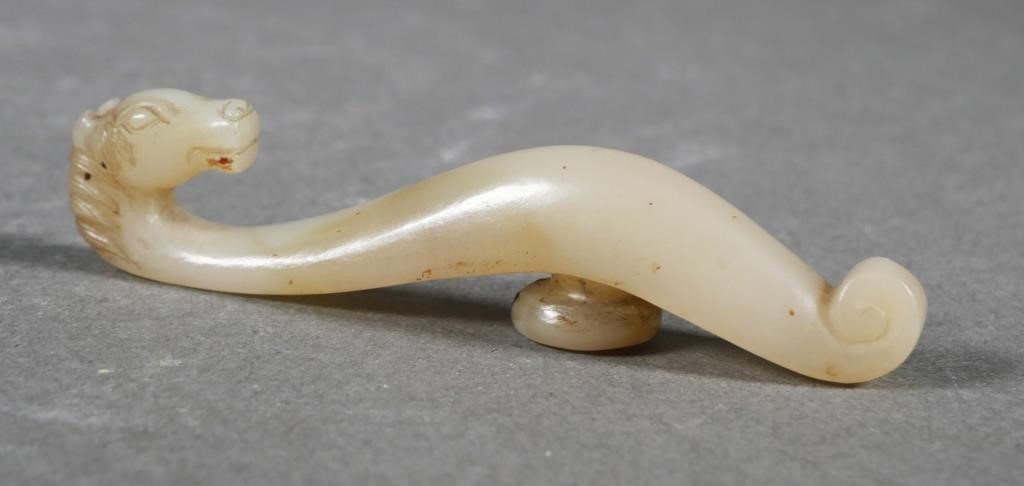 Appraisal: Chinese white jade carved into a figural horse belt hook