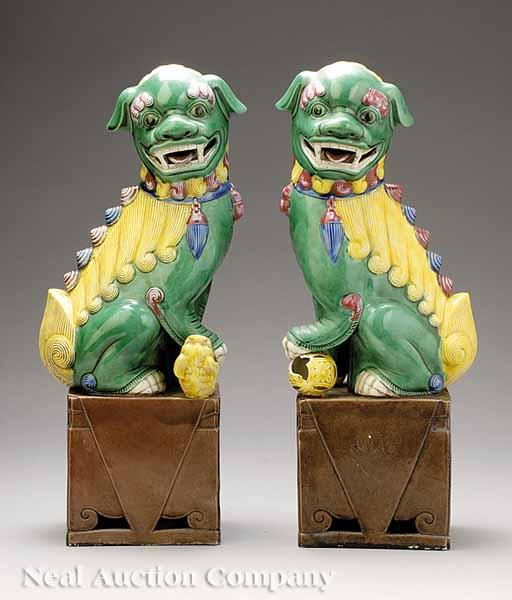 Appraisal: A Pair of Chinese Glazed Buddhistic Lions the green yellow