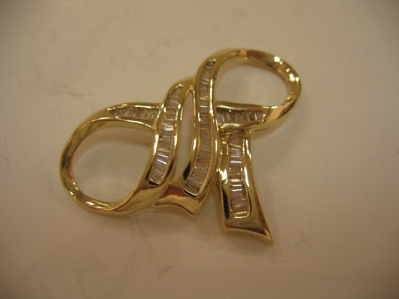 Appraisal: DIAMOND SLIDE k yellow gold bow design slide pendant set