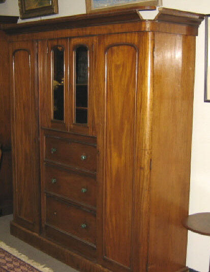 Appraisal: ENGLISH VICTORIAN MAHOGANY WARDROBE The mounded cornice above a pair