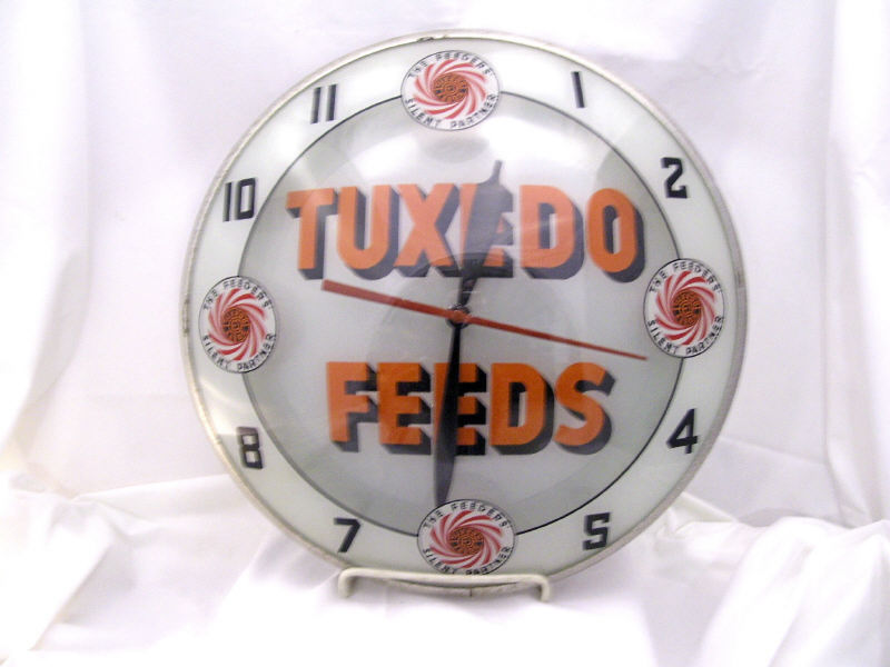 Appraisal: Tuxedo Feeds Bubble Face Clock Bubble face clock White background