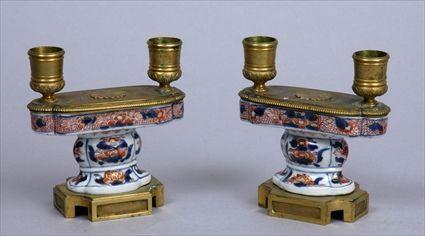 Appraisal: PAIR OF REGENCE-STYLE GILT-METAL AND IMARI PORCELAIN TWO-LIGHT SHORT CANDELABRA