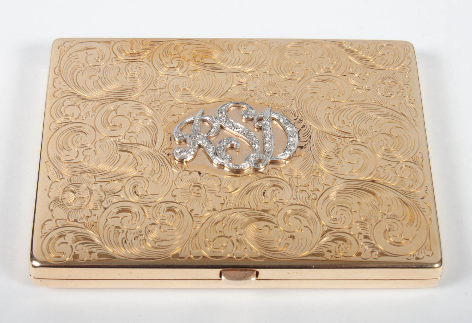 Appraisal: Lady's K engraved gold compact with diamond accented monogram RSD