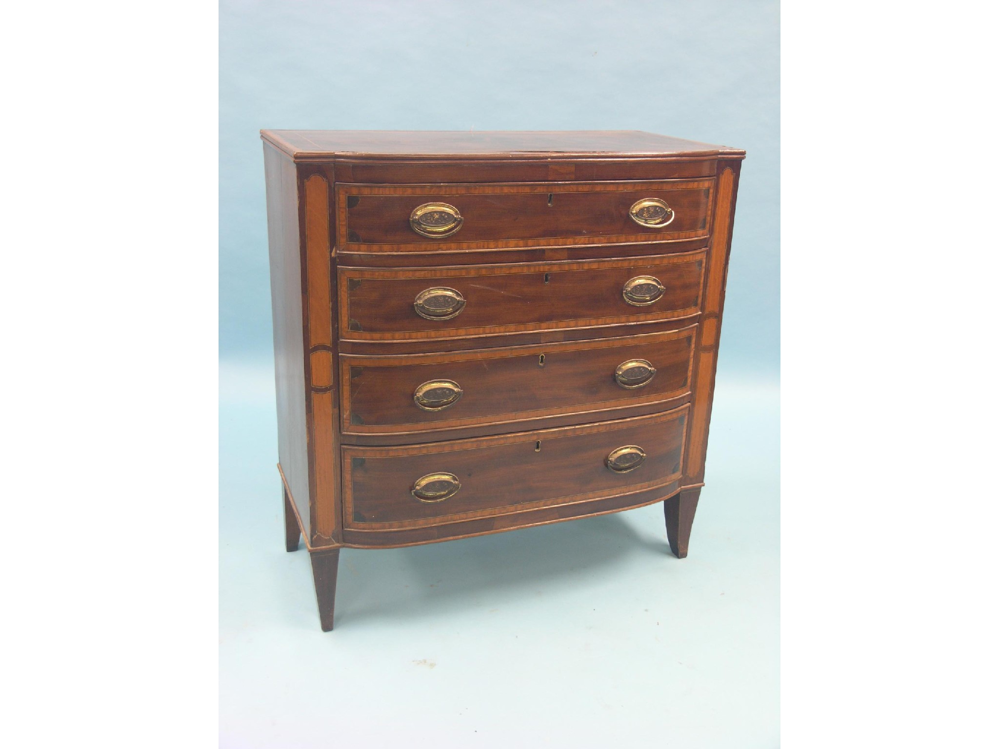 Appraisal: An early th century inlaid mahogany chest four graduated drawers