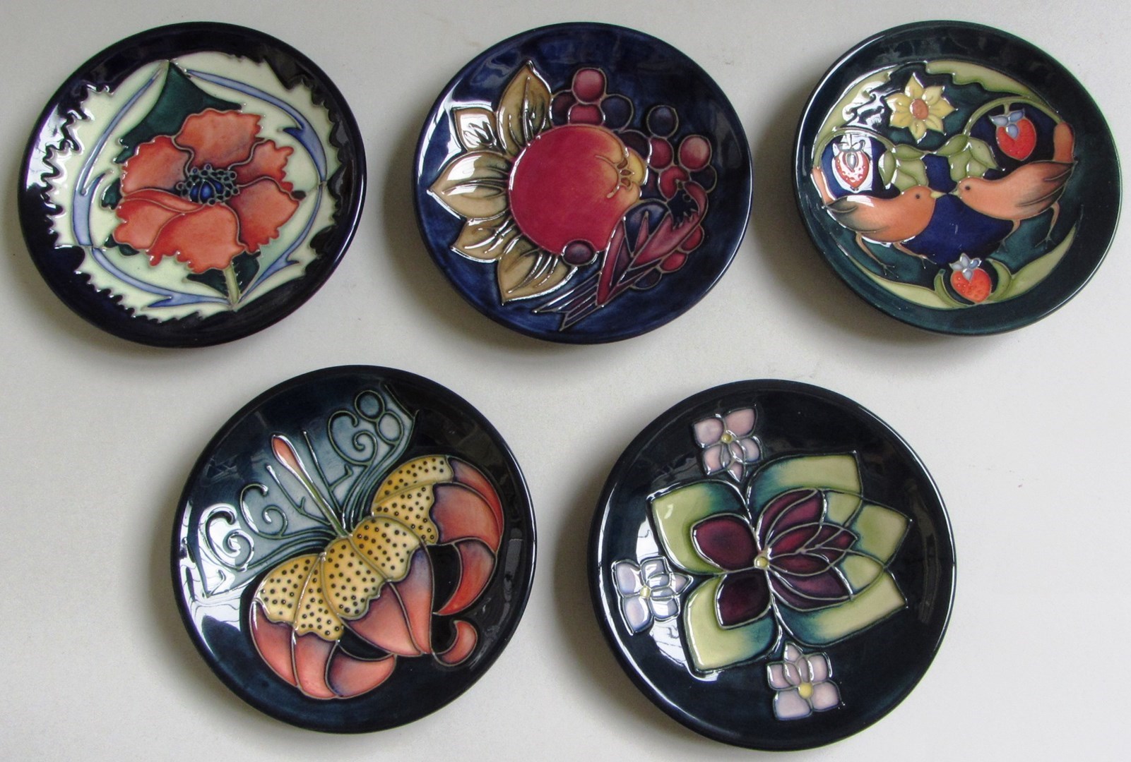 Appraisal: Five Moorcroft pottery dishes late th century each tube line