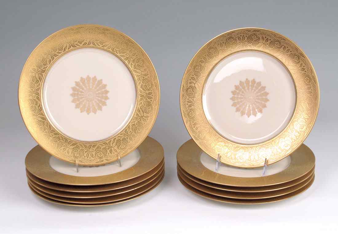 Appraisal: HEINRICH FINE CHINA SERVICE PLATES Wide embossed gold rim with