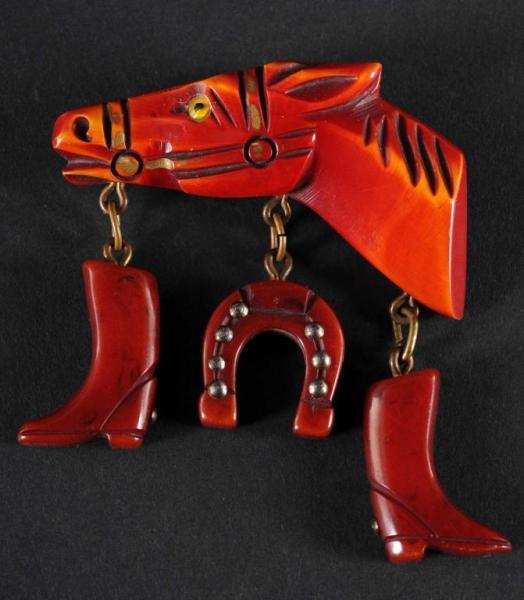 Appraisal: Bakelite Dark Red Horse Head Description With hanging boots and