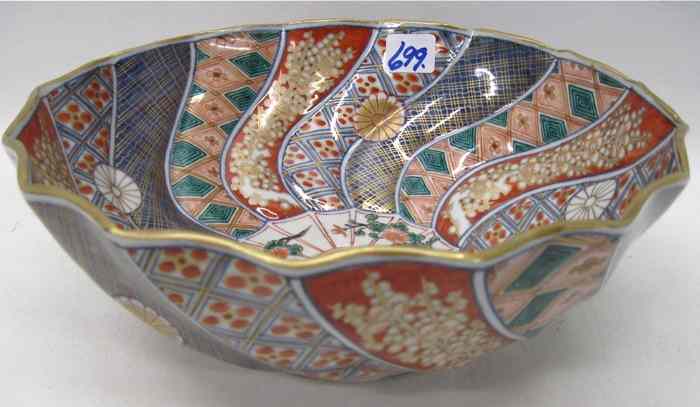 Appraisal: JAPANESE IMARI PORCELAIN BOWL having curved-raised panels of stylized flowers