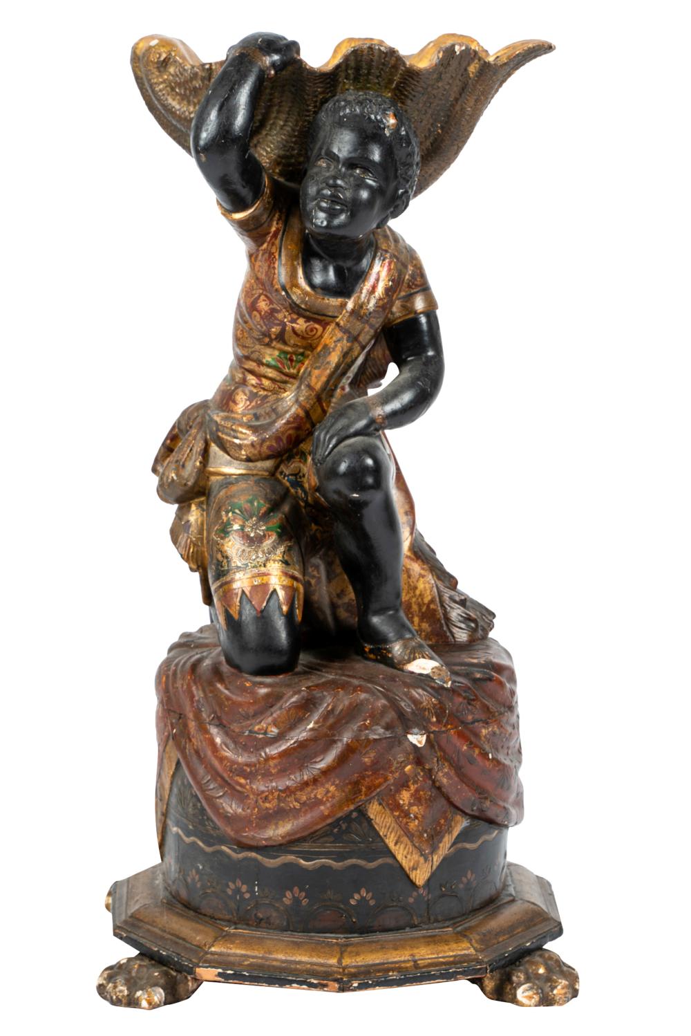 Appraisal: VENETIAN POLYCHROMED WOOD BLACKAMOOR FIGUREsupporting a giltwood shell Provenance The