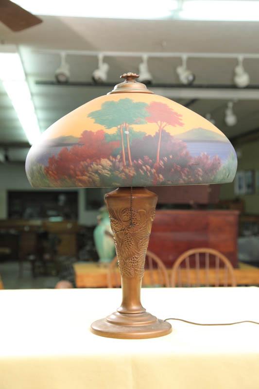 Appraisal: REVERSE PAINTED TABLE LAMP Shade has a reverse painted forest