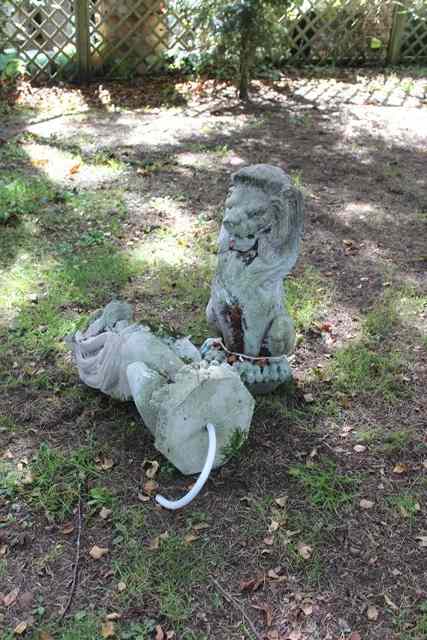 Appraisal: A PAIR OF RECONSTITUTED STONE LION FOUNTAIN HEADS each lion