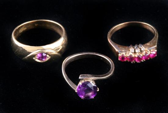 Appraisal: THREE YELLOW GOLD AND COLORED GEMSTONE RINGS One K with