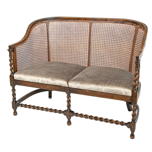 Appraisal: A spiral turned oak twin seat settee with caned back