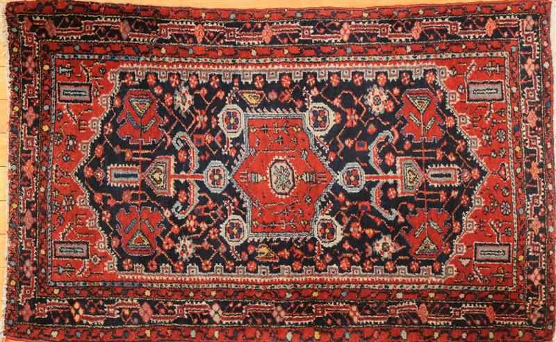 Appraisal: PERSIAN COBALT-GROUND RUG With shaped tomato medallion and mihrabs within