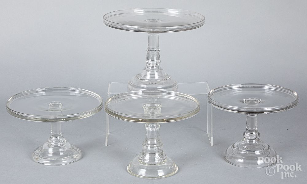 Appraisal: Four colorless glass cake stands Four colorless glass cake stands