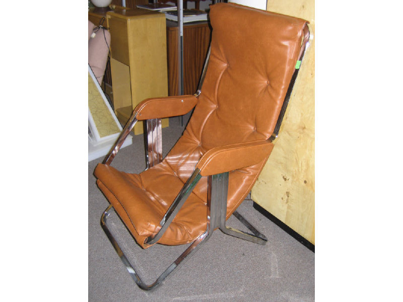 Appraisal: CHROMED TUBULAR SWING CHAIR orange vinyl upholstery raised on square