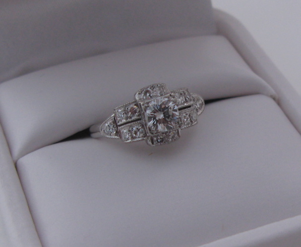 Appraisal: DIAMOND AND TEN KARAT WHITE GOLD RING centering a round-cut