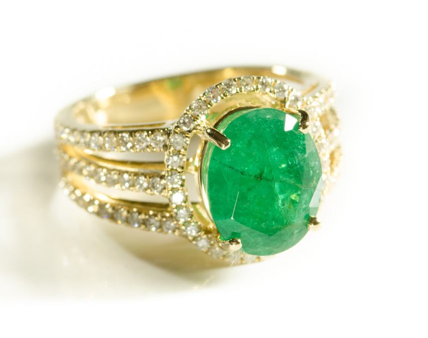 Appraisal: EMERALD DIAMOND AND FOURTEEN KARAT GOLD RING with round-cut diamonds