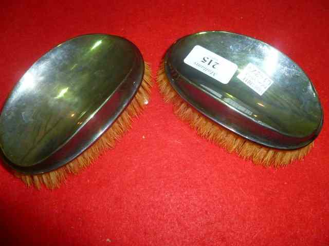 Appraisal: A PAIR OF GENTLEMAN'S SILVER BACKED HAIRBRUSHES of plain form