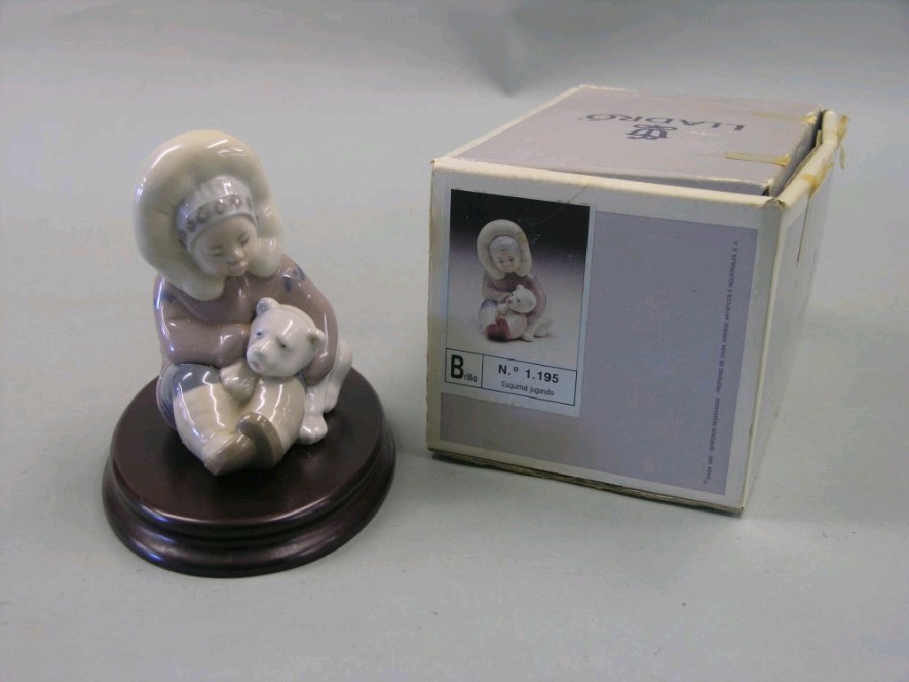 Appraisal: A Lladro child eskimo infant seated with polar bear cub