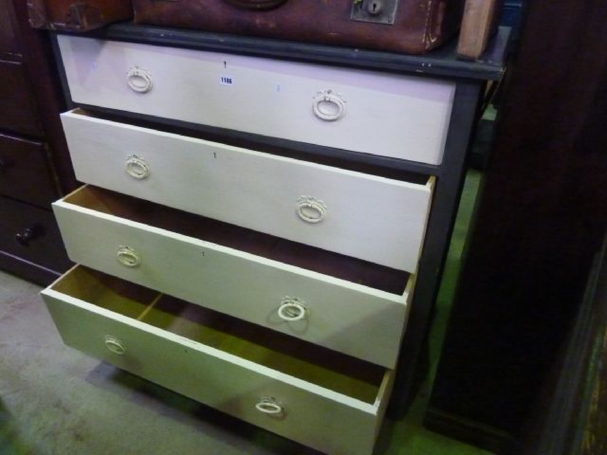 Appraisal: A painted chest of four long drawers with embossed handles