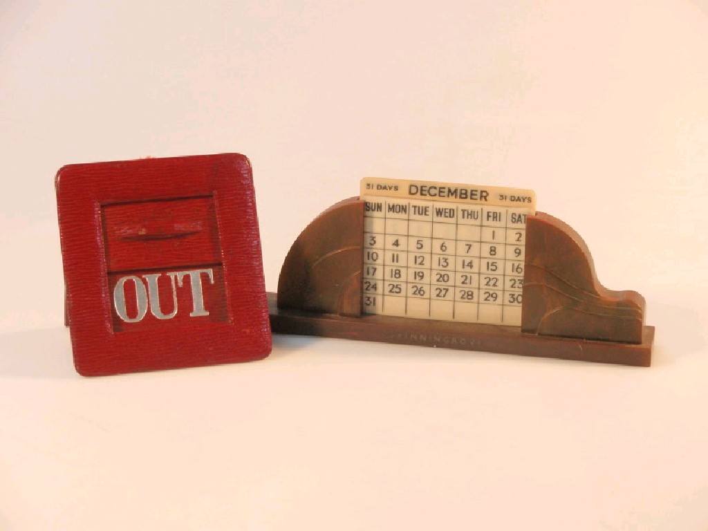 Appraisal: An Art Deco bakelite perpetual desk calendar with celluloid month