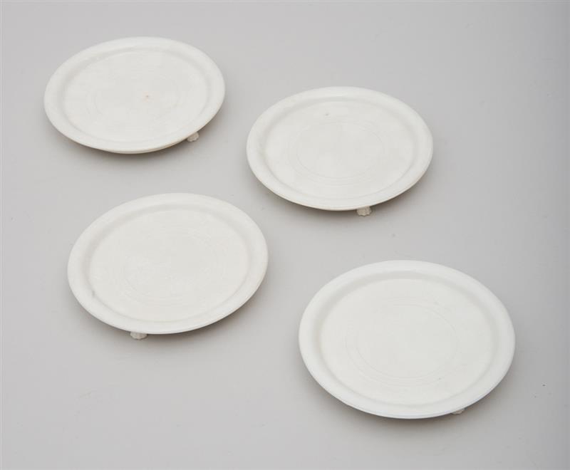 Appraisal: GROUP OF FOUR FOOTED PORCELAIN BOTTLE COASTERS in diam Property