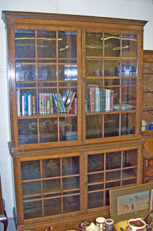 Appraisal: An Edwardian oak library bookcase fitted glazed doors -