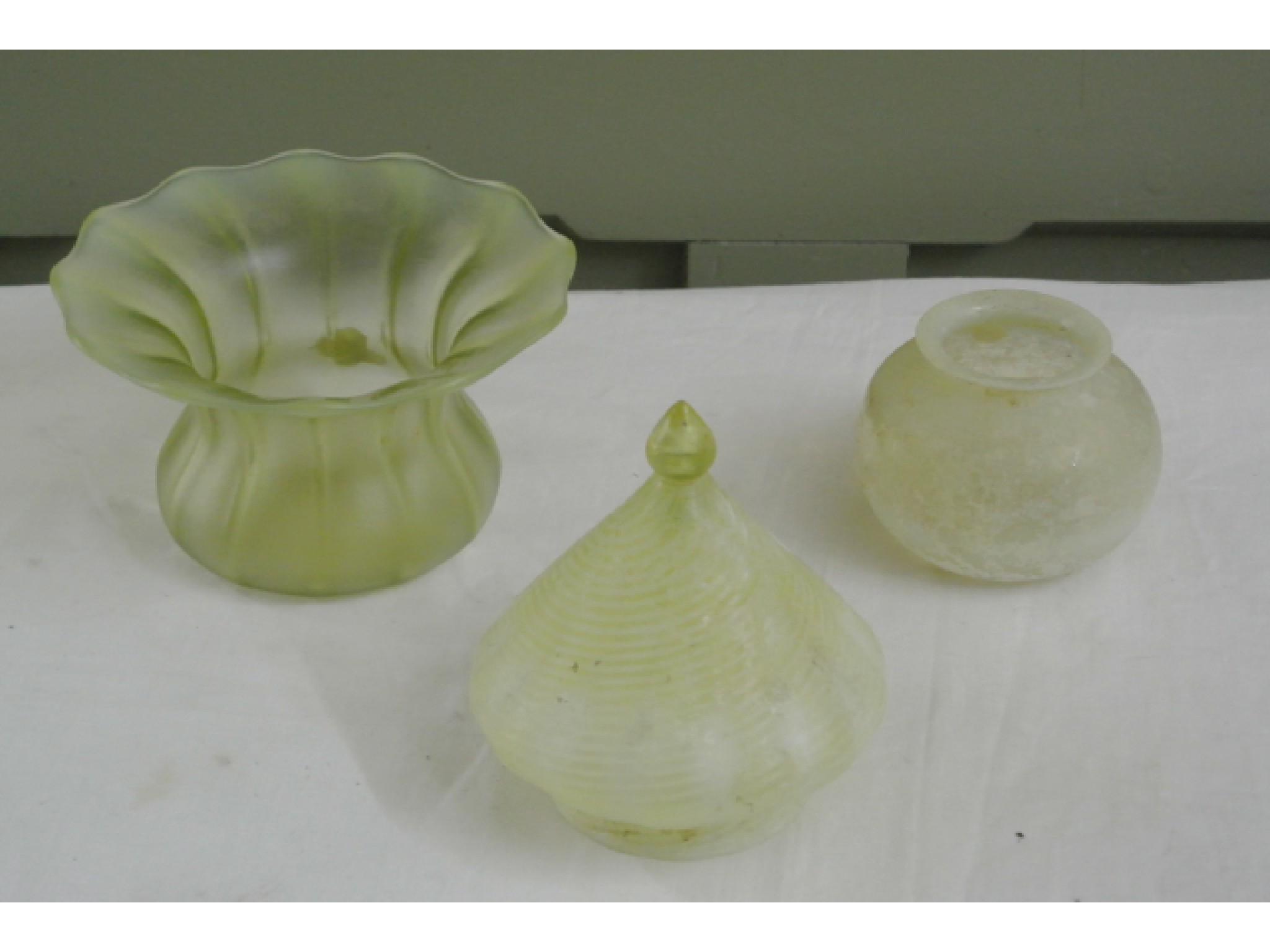 Appraisal: A small Vaseline glass conical shade with wrythen striped detail