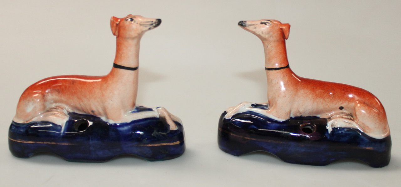 Appraisal: A pair of Staffordshire pottery greyhound ink stands each polychrome