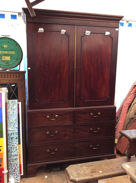 Appraisal: A GEORGE III MAHOGANY LINEN PRESS the two panelled doors