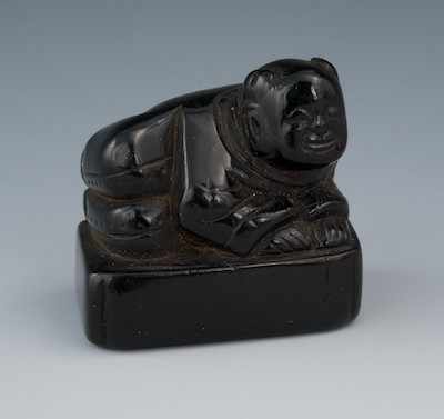 Appraisal: A Carved Ebony Netsuke of a Reclining Man th Century