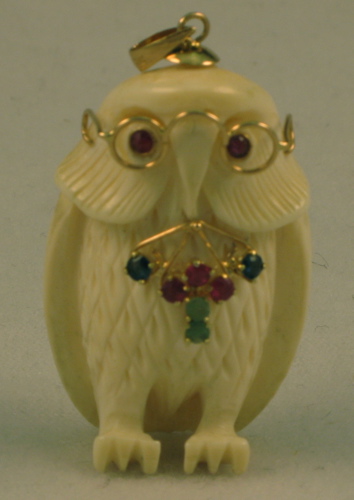 Appraisal: RUBY SAPPHIRE EMERALD AND FOURTEEN KARAT GOLD CARVED BONE OWL