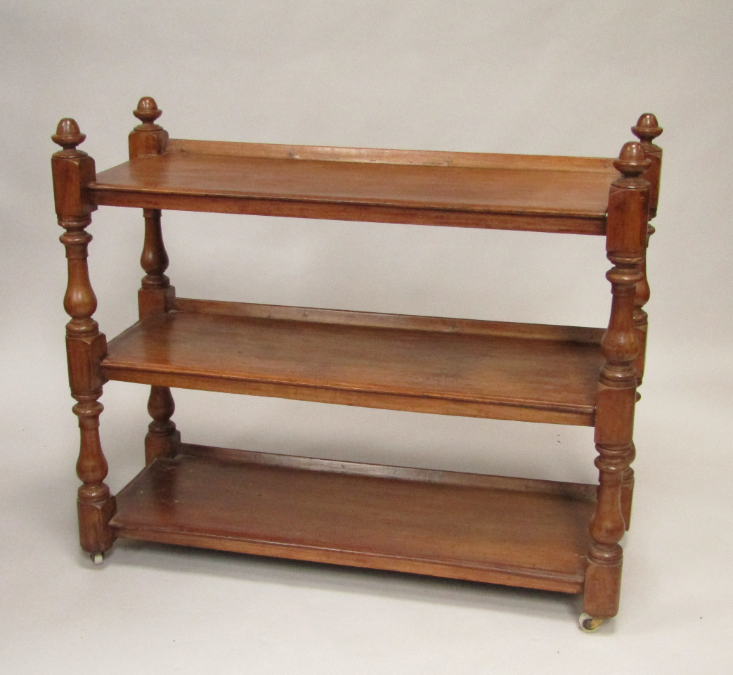 Appraisal: A Victorian mahogany three tier buffet raised on baluster turned