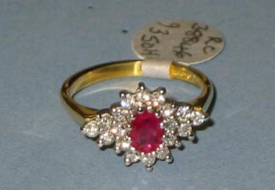 Appraisal: A RUBY AND DIAMOND CLUSTER RING having central oval cut