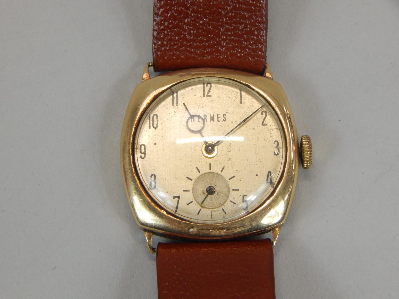 Appraisal: A gent's Hermes wristwatch on tan leather strap with yellow