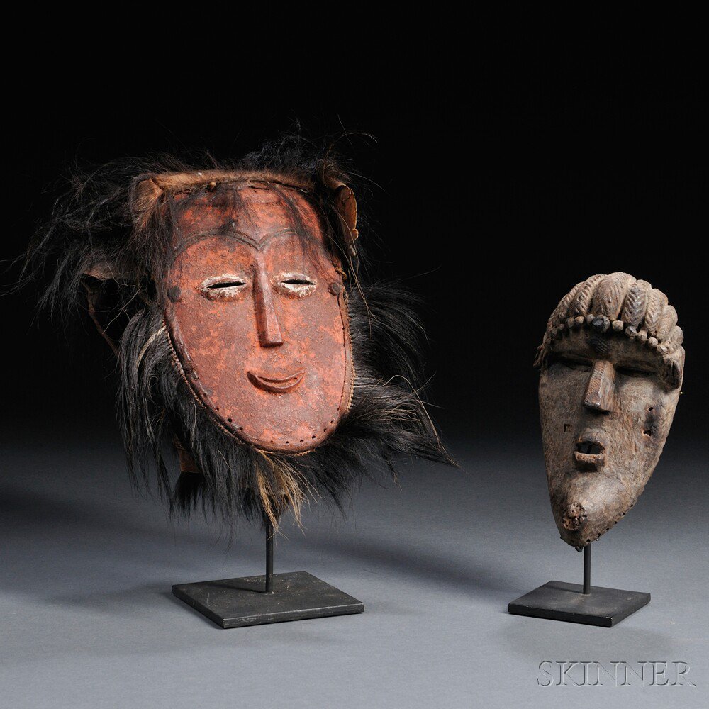 Appraisal: Two African Masks a small carved wood Bassa mask and