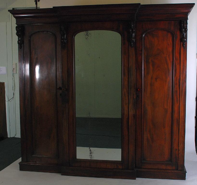 Appraisal: EARLY VICTORIAN MAHOGANY THREE DOOR BREAKFRONT WARDROBE the moulded cornice