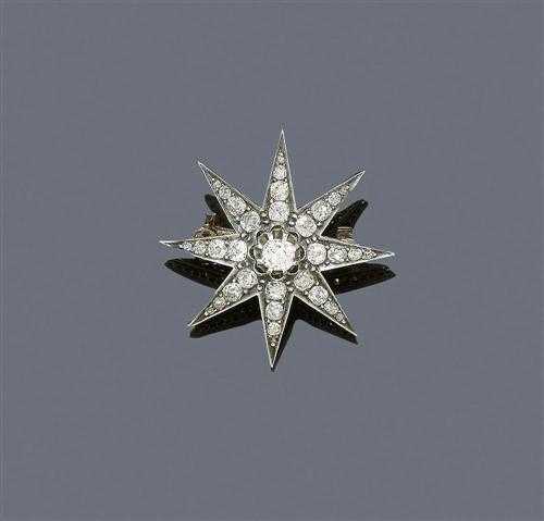 Appraisal: DIAMOND BROOCH ca Silver over yellow gold Charming star motif