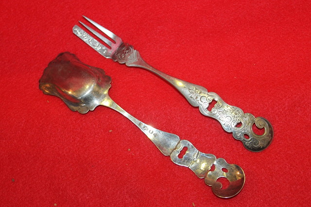 Appraisal: A PAIR OF DUTCH SILVER PASTRY TOOLS with pierced and