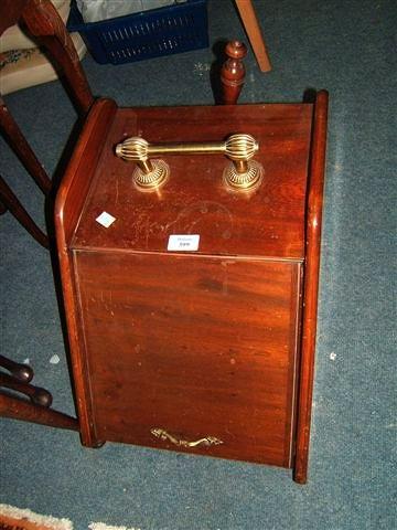 Appraisal: A mahogany coal scuttle with brass handles together with a