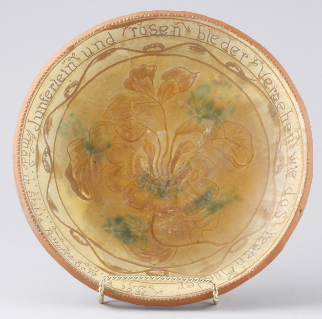 Appraisal: Redware plate features floral motif at center with verse in