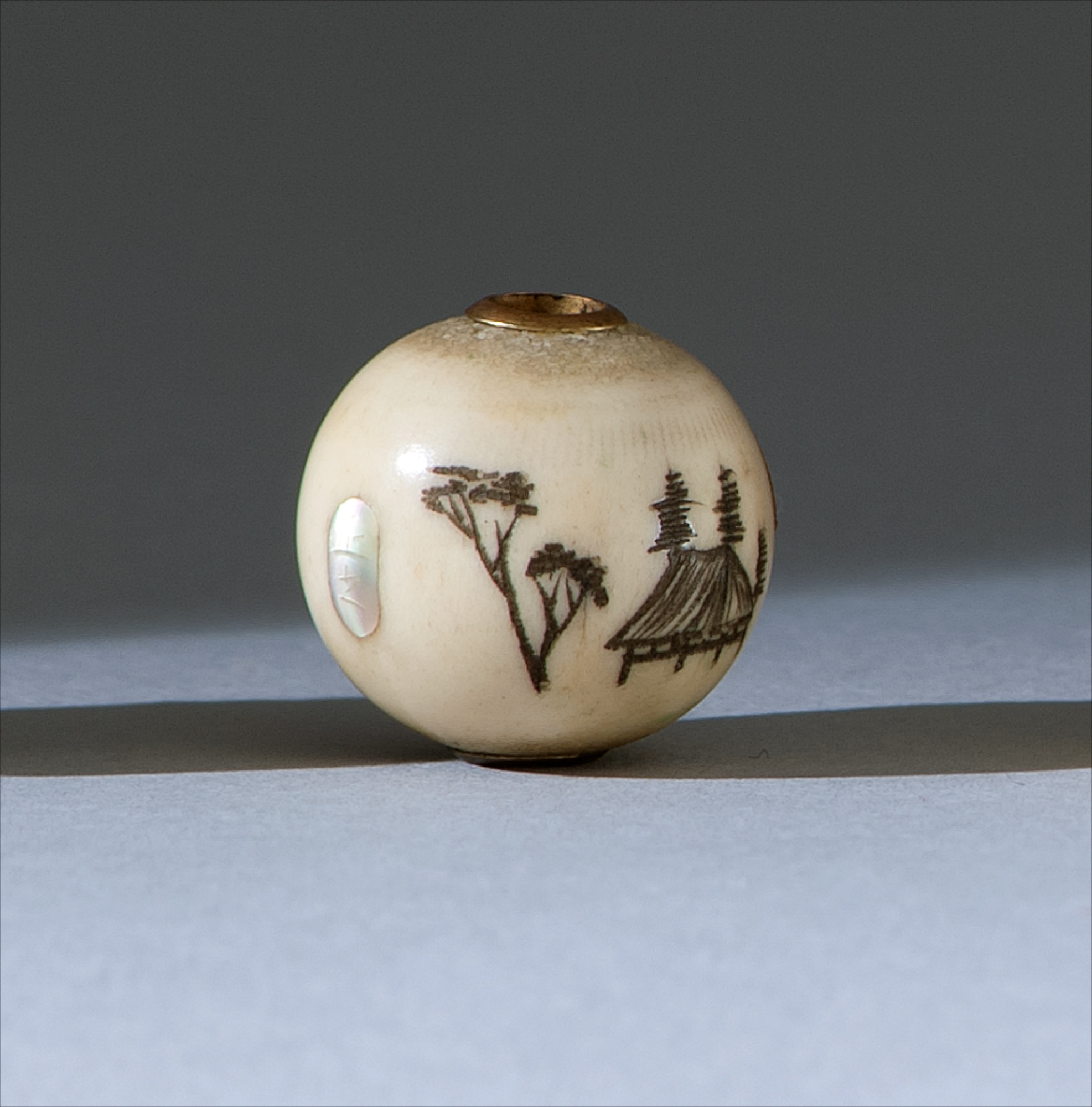 Appraisal: STAGHORN OJIME Meiji PeriodWith engraved landscape design Signed Masayuki Diameter